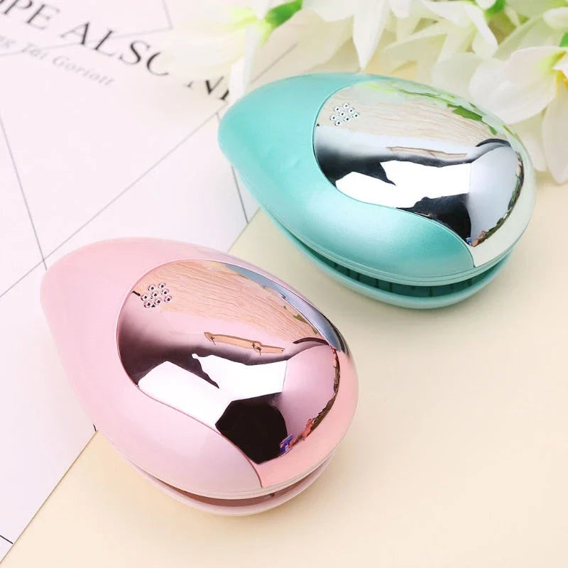 Portable negative ion hair comb with sound wave vibration technology in pink and green