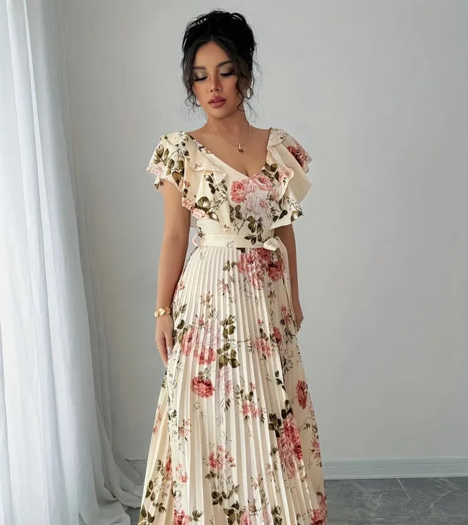 Apricot coloured floral print V-neck dress with ruffled sleeves and a pleated swing skirt.