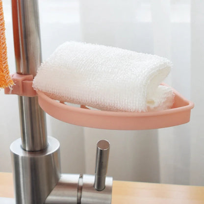 Clip-on adjustable sink drain basket in pink and light green, organising soap and towels