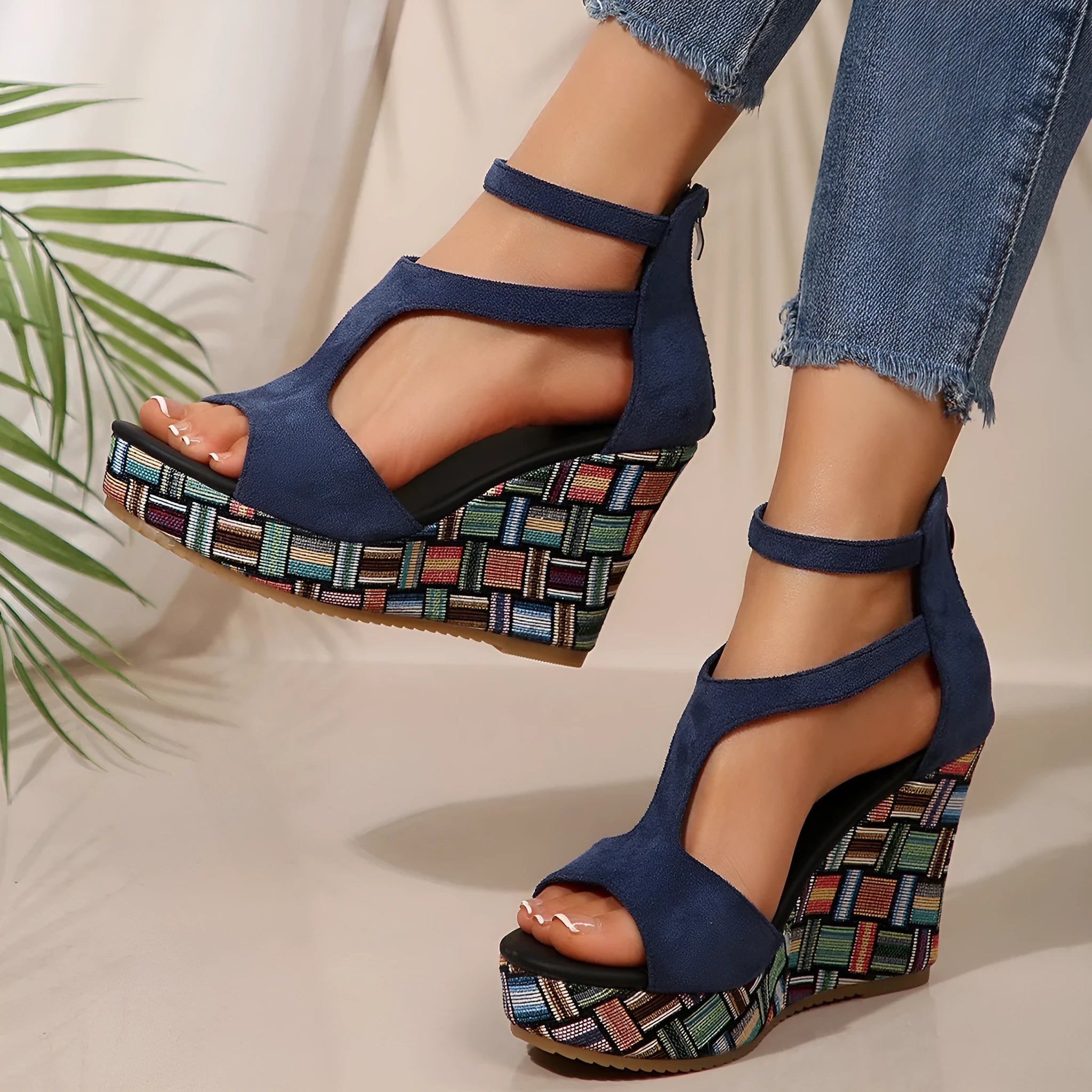 Women's beige wedge sandals with a thick rubber sole and buckle ankle strap on a cloth upper.