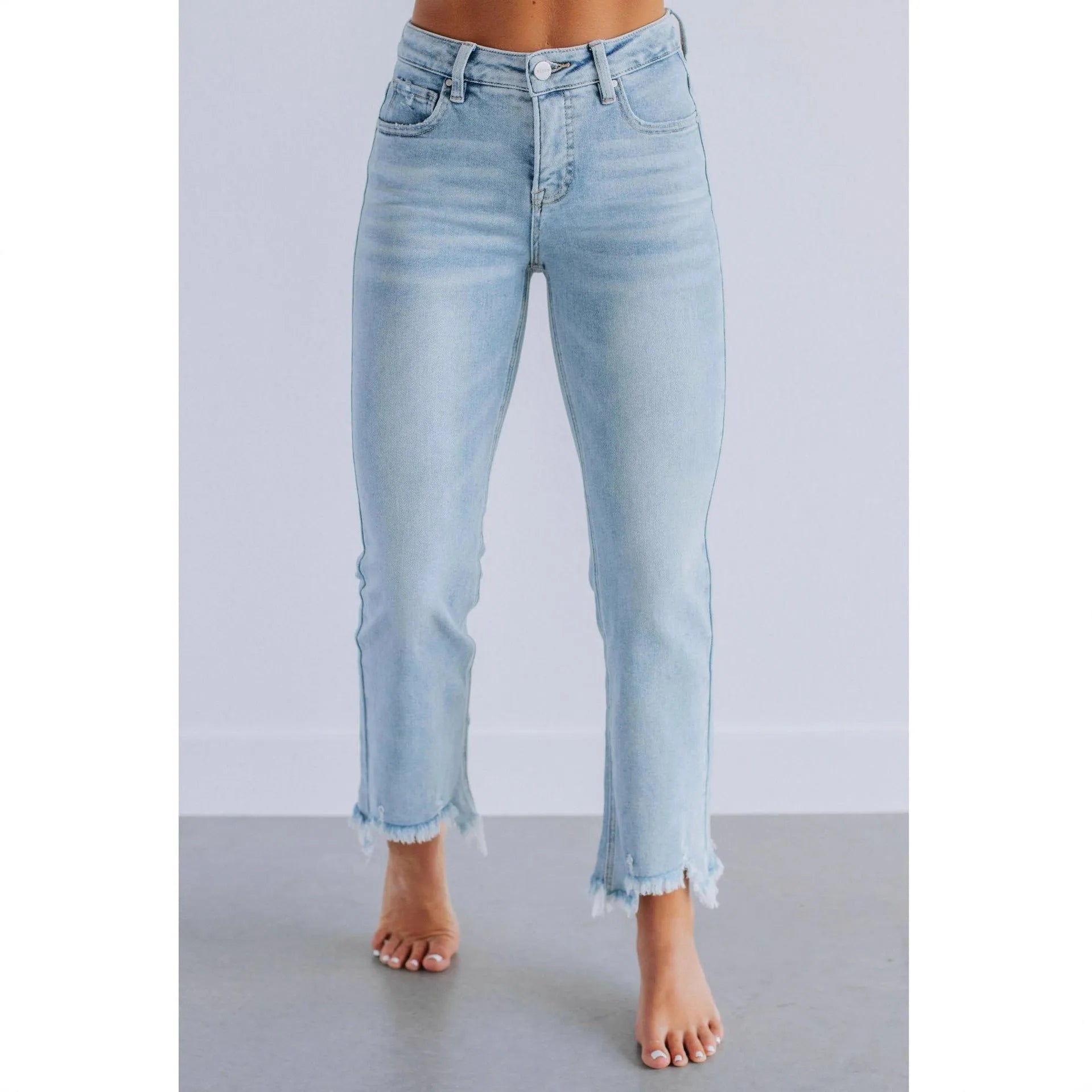 Women's solid colour denim jeans with a hand-worn distressed finish in dark blue.