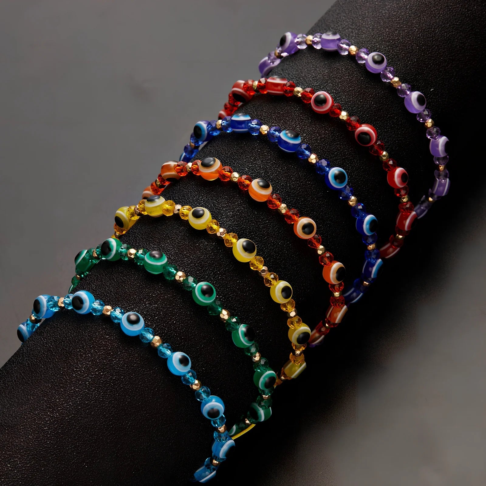 Adjustable crystal bead bracelet with blue eye design on braided rope, fits 15-19cm wrists