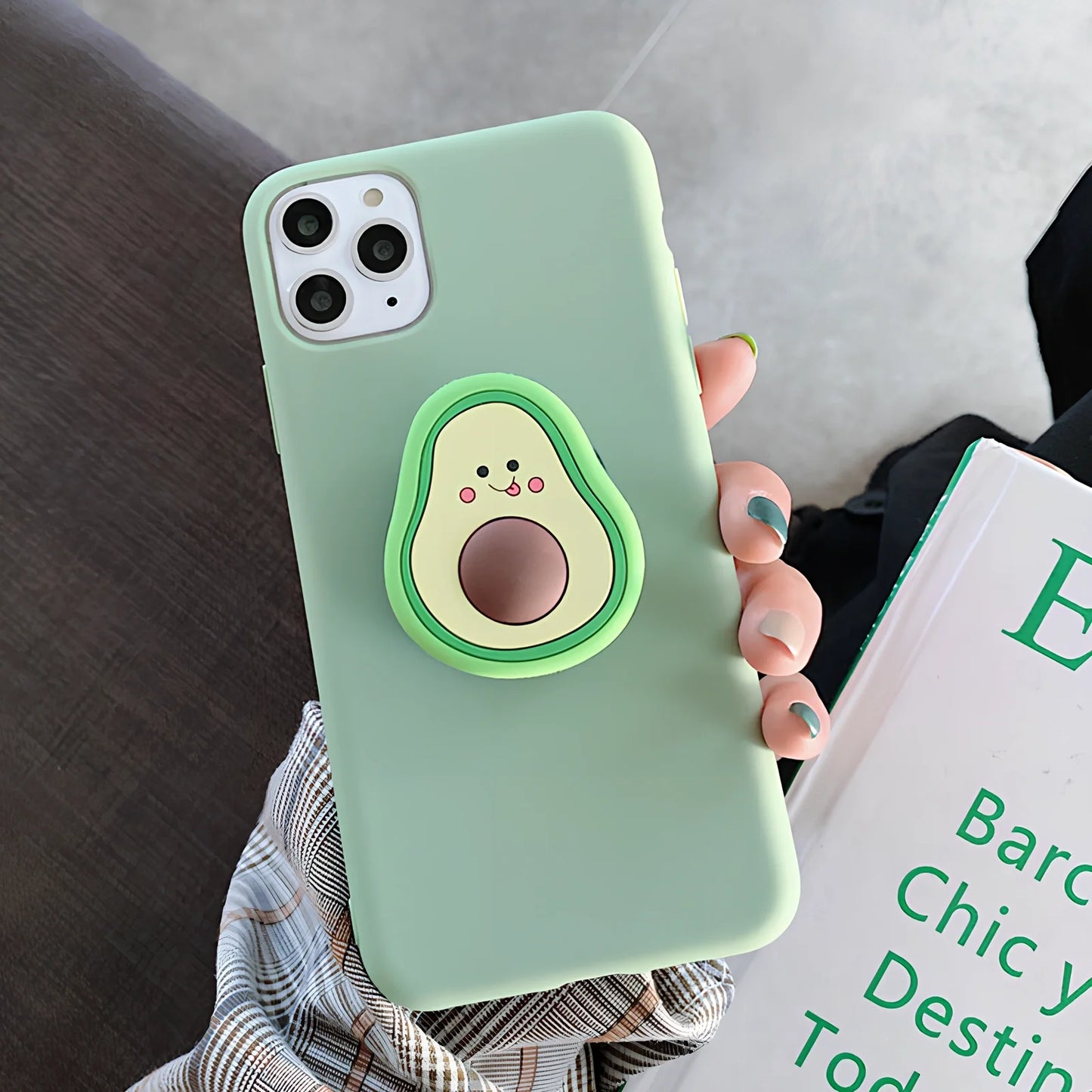 Green avocado pattern silicone iPhone case with metal ring stand attached to back