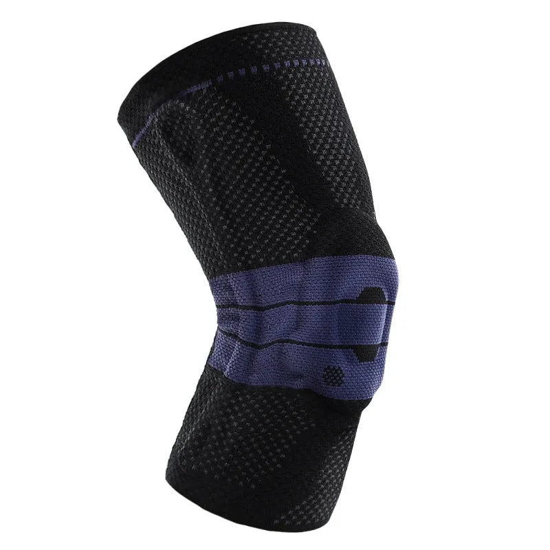 A pair of adult sports knee pads in a black and blue colourway, shown on a knee for scale.