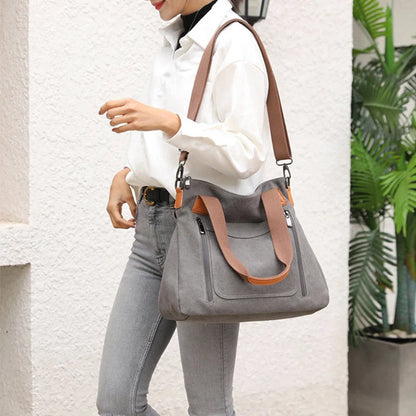 Women's canvas shoulder bag in multiple colours, showcasing spacious interior and zipper closure.
