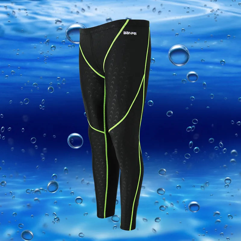 Men's black and grey cropped nylon swimming trunks with mesh lining laid flat.