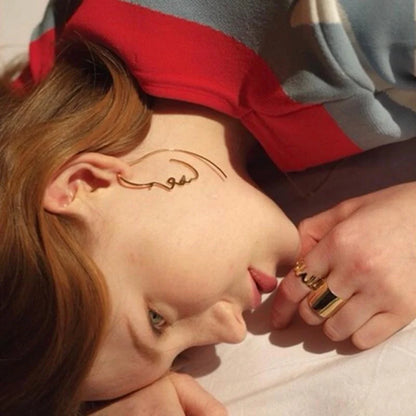 Abstract face contour earrings in gold and silver, 75mm x 35mm