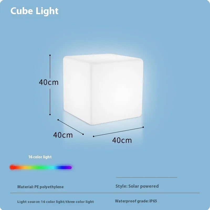 A modern white LED cube light stool sitting outdoors on a patio.