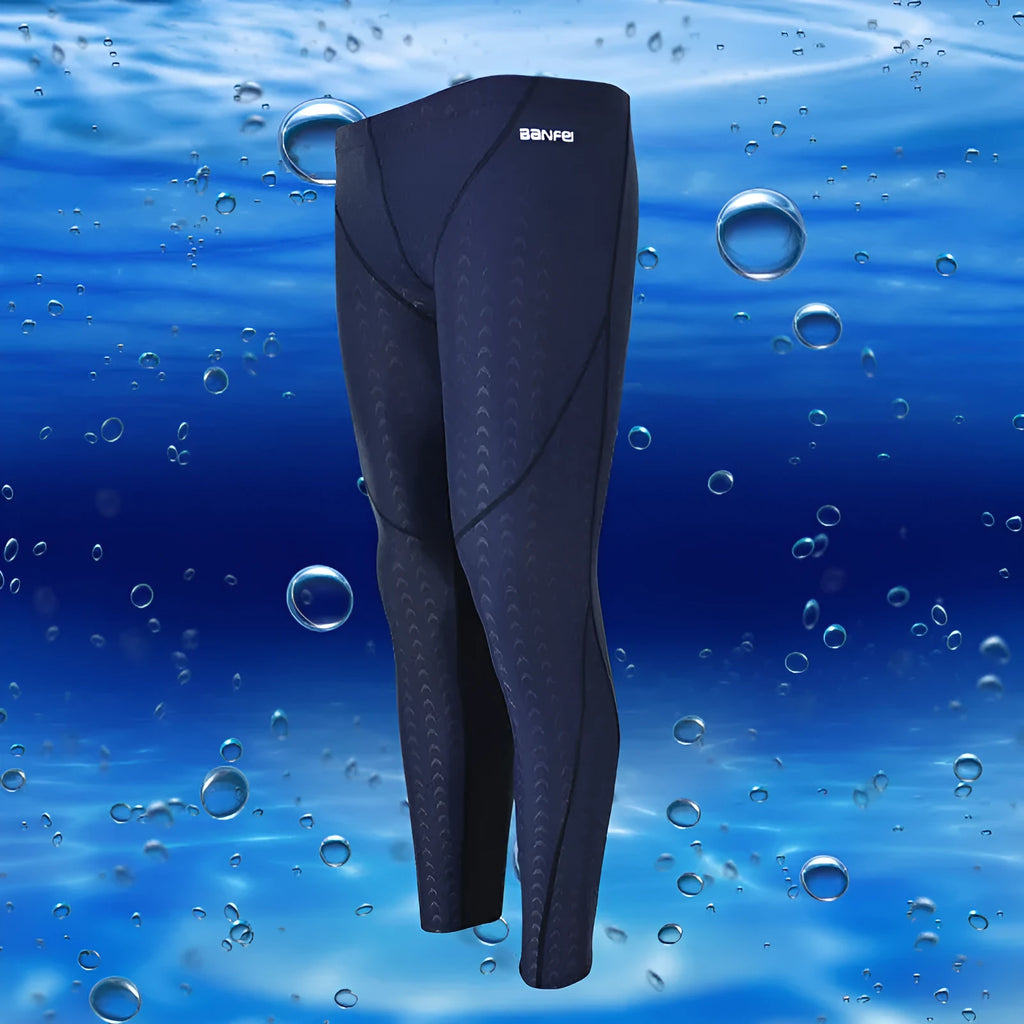 Men's black and grey cropped nylon swimming trunks with mesh lining laid flat.