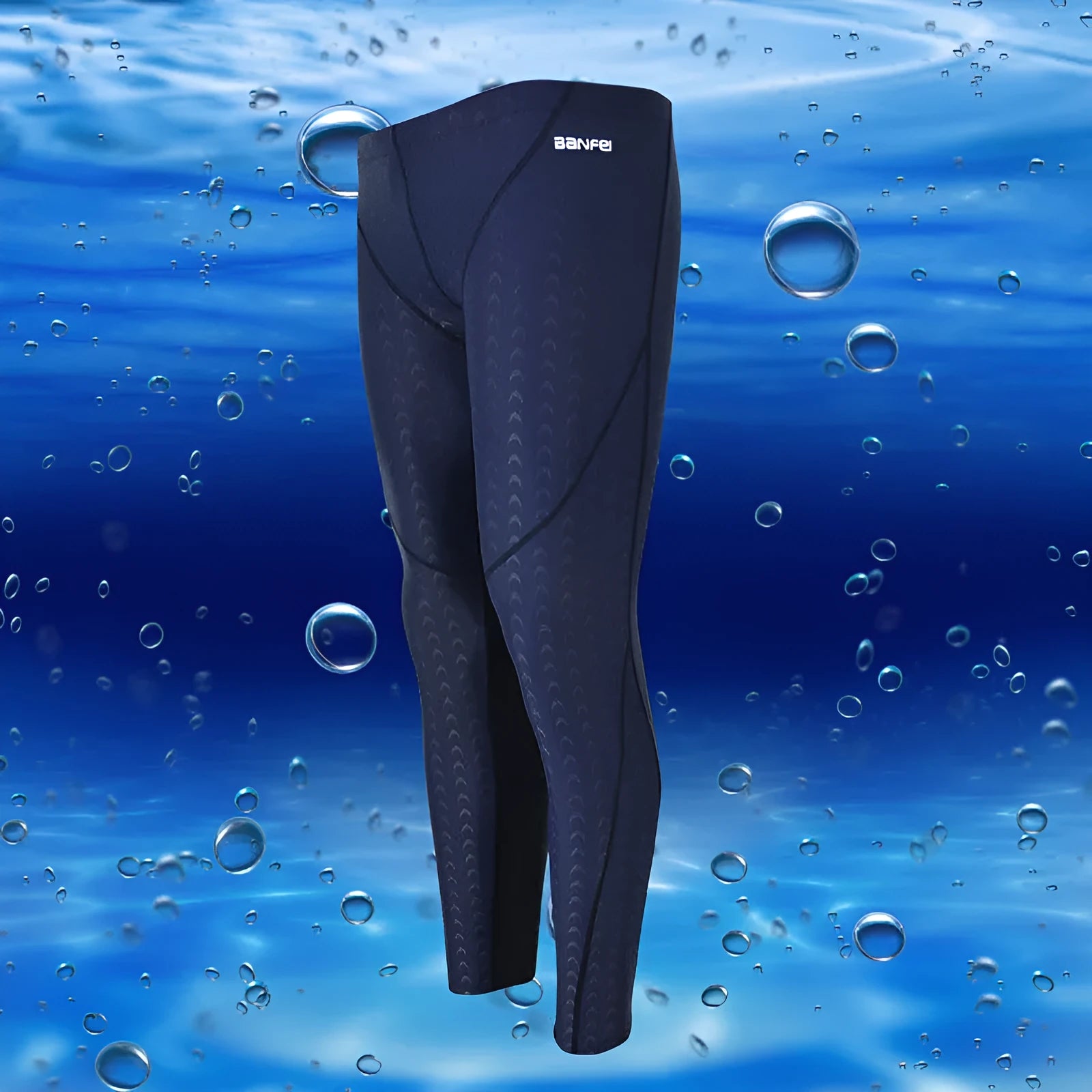 Men's black and grey cropped nylon swimming trunks with mesh lining laid flat.
