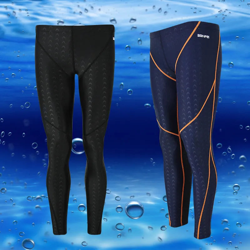 Men's black and grey cropped nylon swimming trunks with mesh lining laid flat.