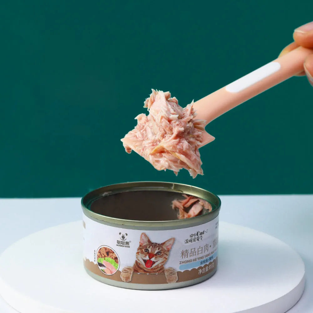 Green TPR pet feeding spoon with a long 16cm handle and right-angle scoop for canned wet food.