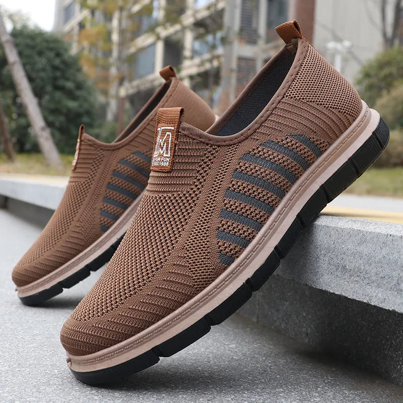 Slip-on soft bottom casual sneakers for men in black with mesh upper and low-top design