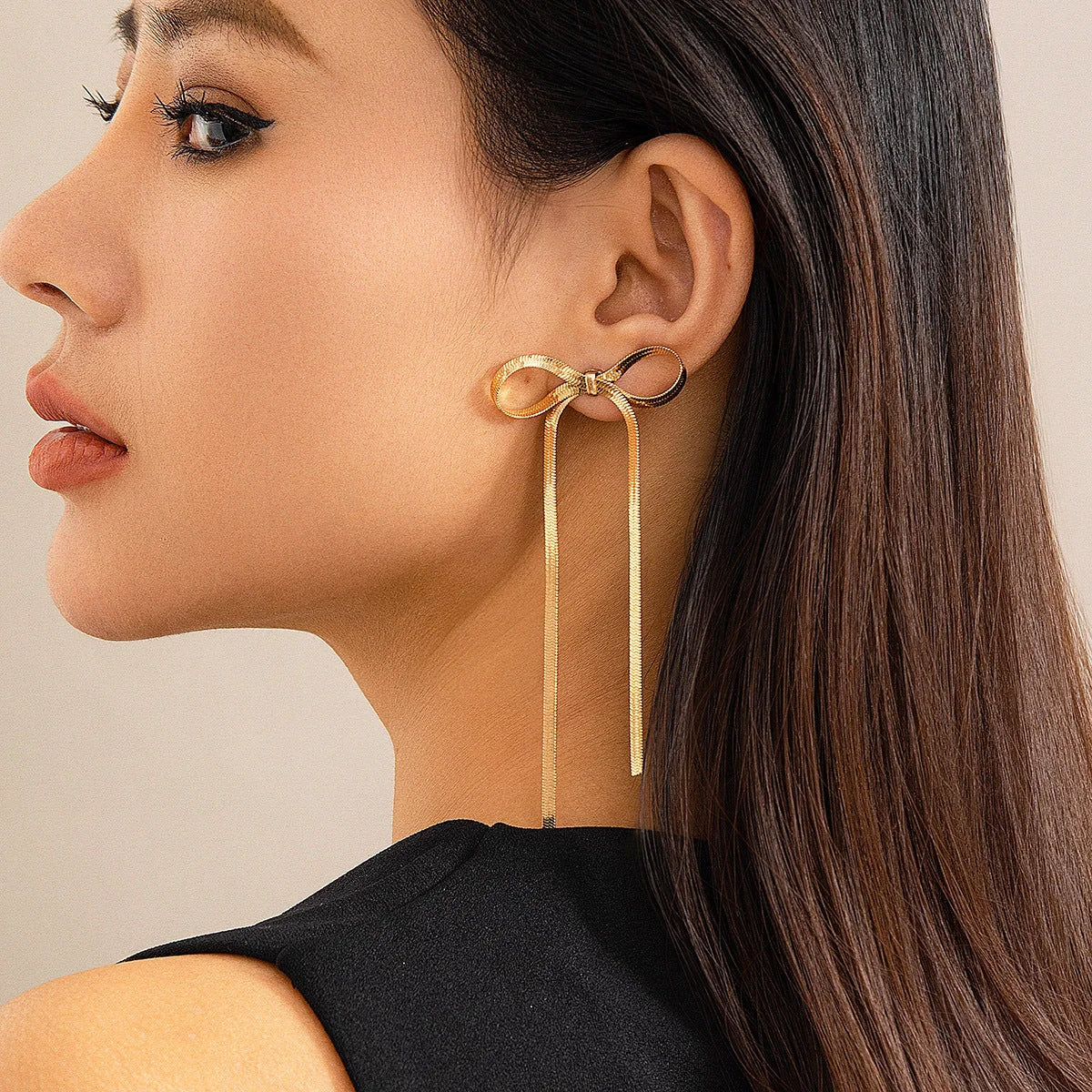 Hypoallergenic 18k gold plated herringbone bow earrings with tassel tails