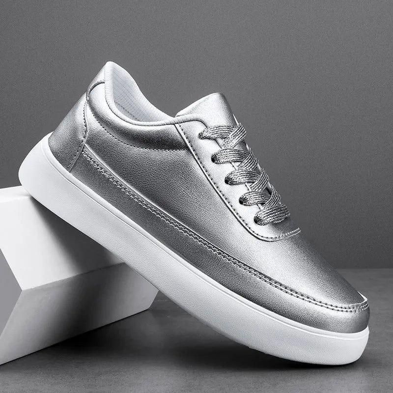 Women's white leather casual flat shoes with front lace-up design on a plain background.
