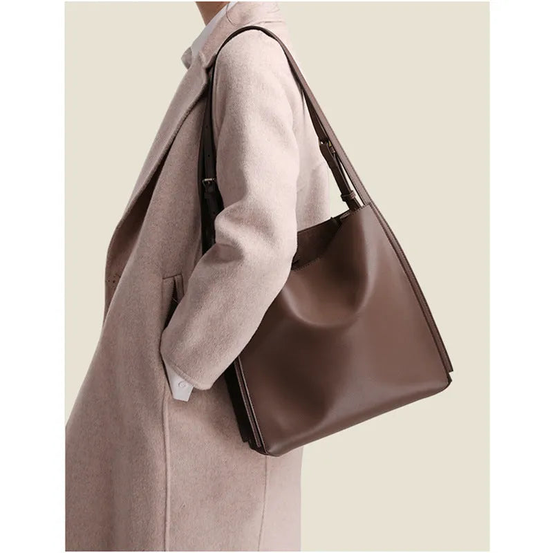 Brown genuine leather women's bucket handbag with double shoulder straps and interior organisation pockets