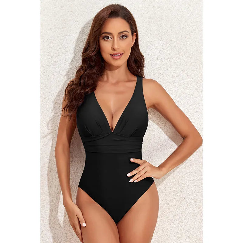 Women's solid colour cross shoulder one-piece swimsuit on a mannequin.