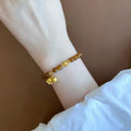 Women's natural stone Lily bracelet with electroplated finish and floral design in caramel beeswax colour