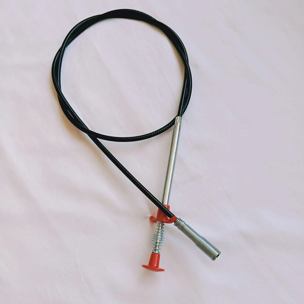 A black sewer dredge spring pipe cleaning tool for unblocking kitchen sink drains