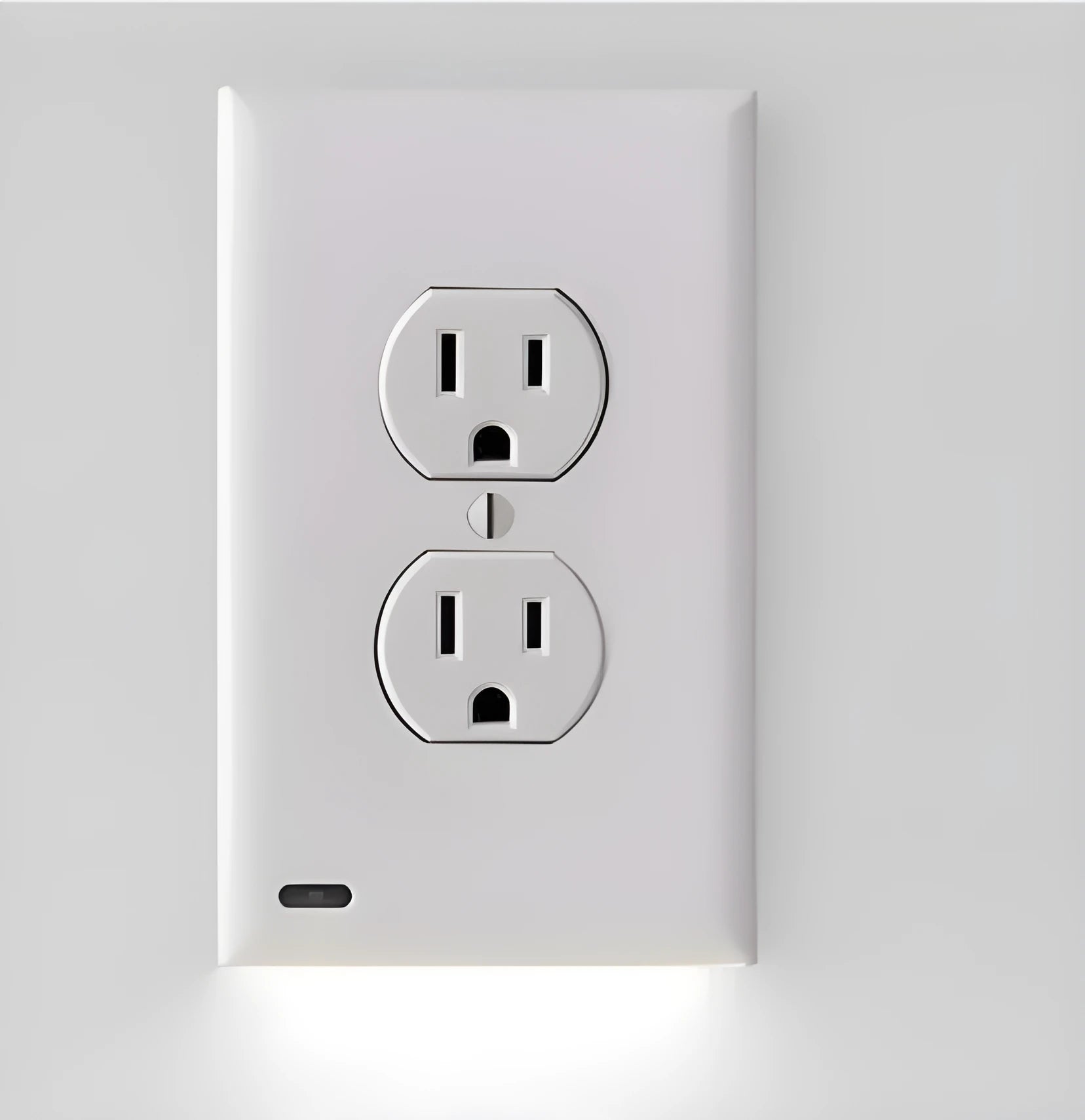 White plug-in LED socket night light installed in a wall socket, showing automatic sensor.