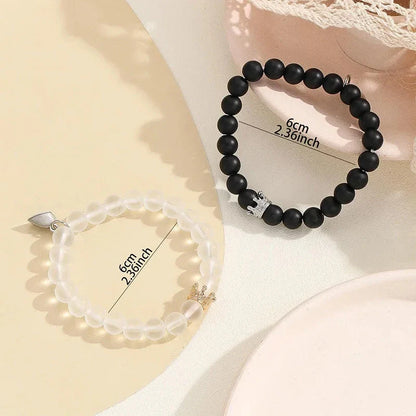 Luminous glow-in-the-dark crown bracelet set in white and black colors, showcasing a unique design and enchanting nighttime glow