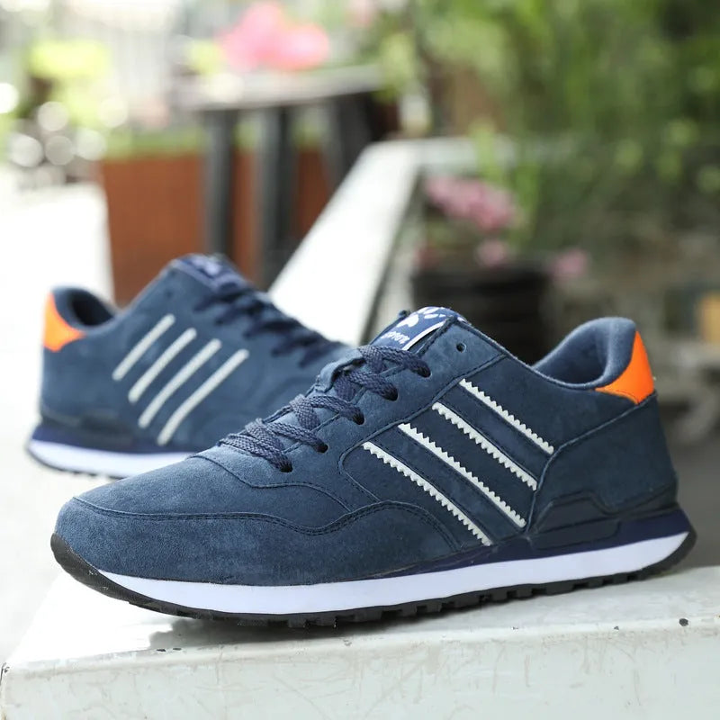 Men's blue pigskin leather sneakers with flat heel and rubber sole on grey background