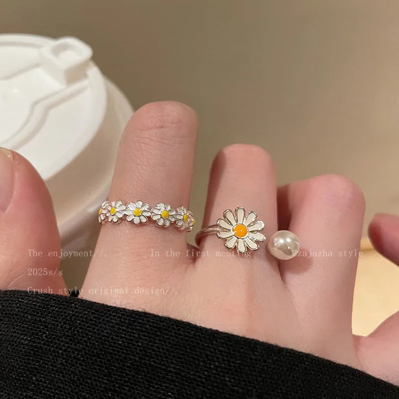 Women's adjustable copper ring set showing little daisy pearl ring and plain daisy ring with opening design.