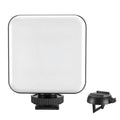 Silver 5600K LED video light cube clipped onto a laptop, with shelf and wire included