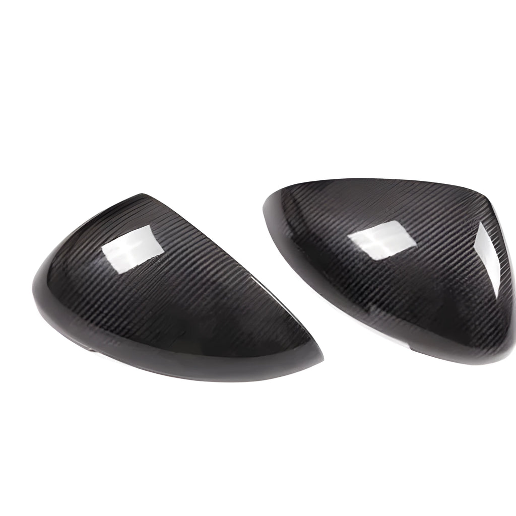 True carbon fibre exterior mirror covers for a Porsche Macan, shown in high-gloss black.