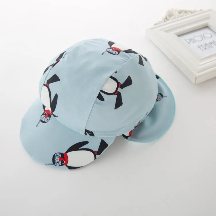 Boys' long sleeve penguin print swimsuit set with matching swim cap for sun protection.