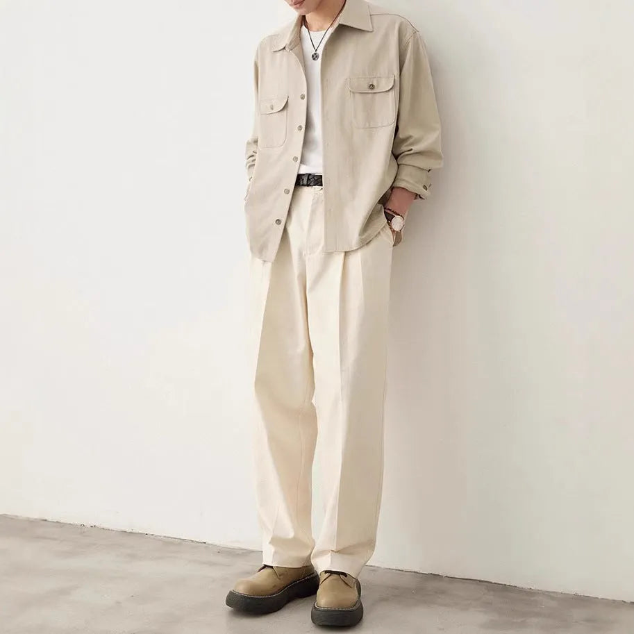 Men's light sand rice coloured casual shirt with simple lapel and long sleeves on a hanger.