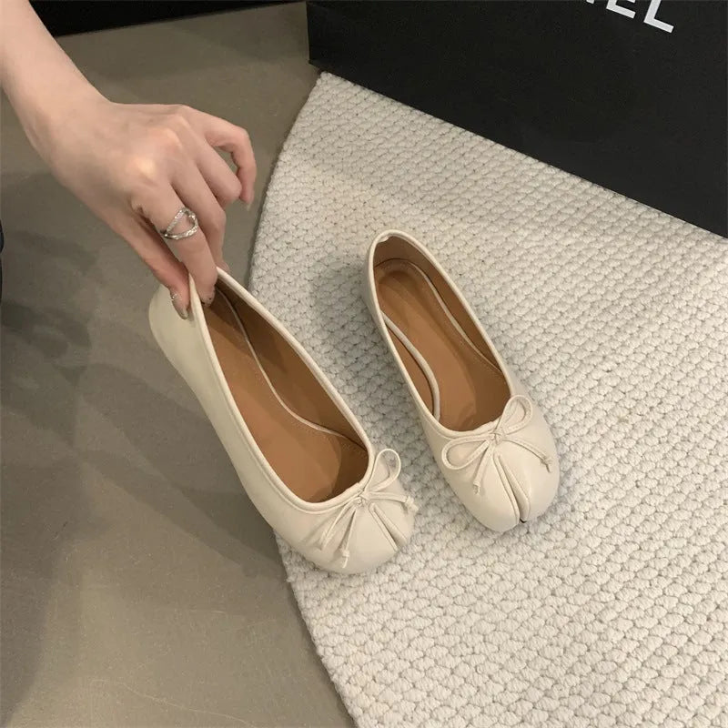 Women's split-toe flats in beige colour showing round toe design and slip-on style with shallow vamp cut