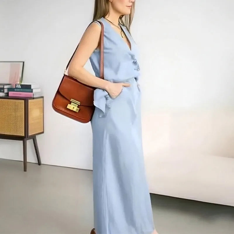 White sleeveless top and long skirt two-piece casual suit set on a model.
