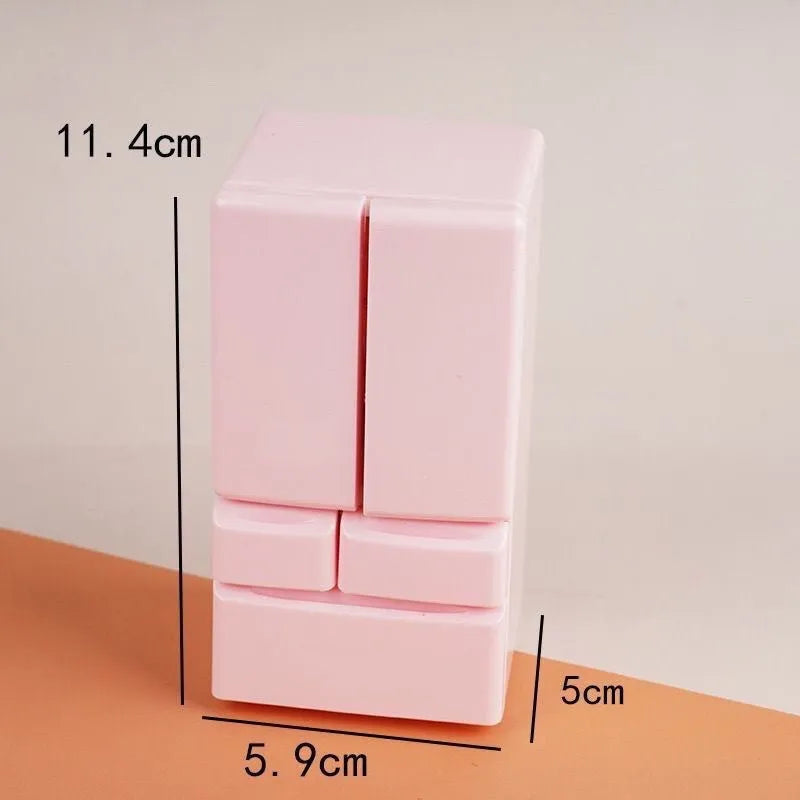 White plastic miniature candy toy model with illuminated light feature on a display surface.