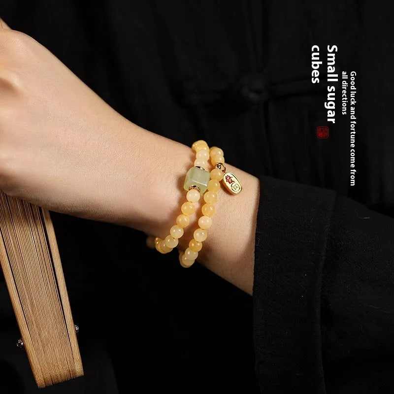 Topaz-coloured women's bracelet with six-word mantra barrel beads and sugar jade cubes in hand-woven design