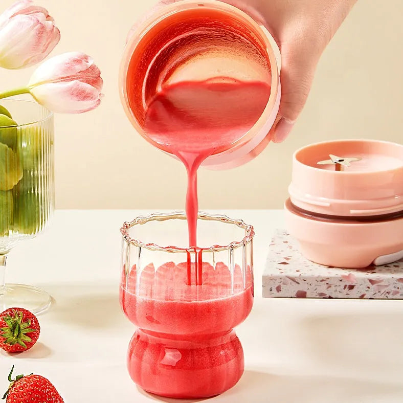 Grape purple portable blender cup with four stainless steel blades and USB charging cable.