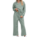 Women's solid colour knitted lapel sweater and elastic waist cropped trousers suit set laid flat.