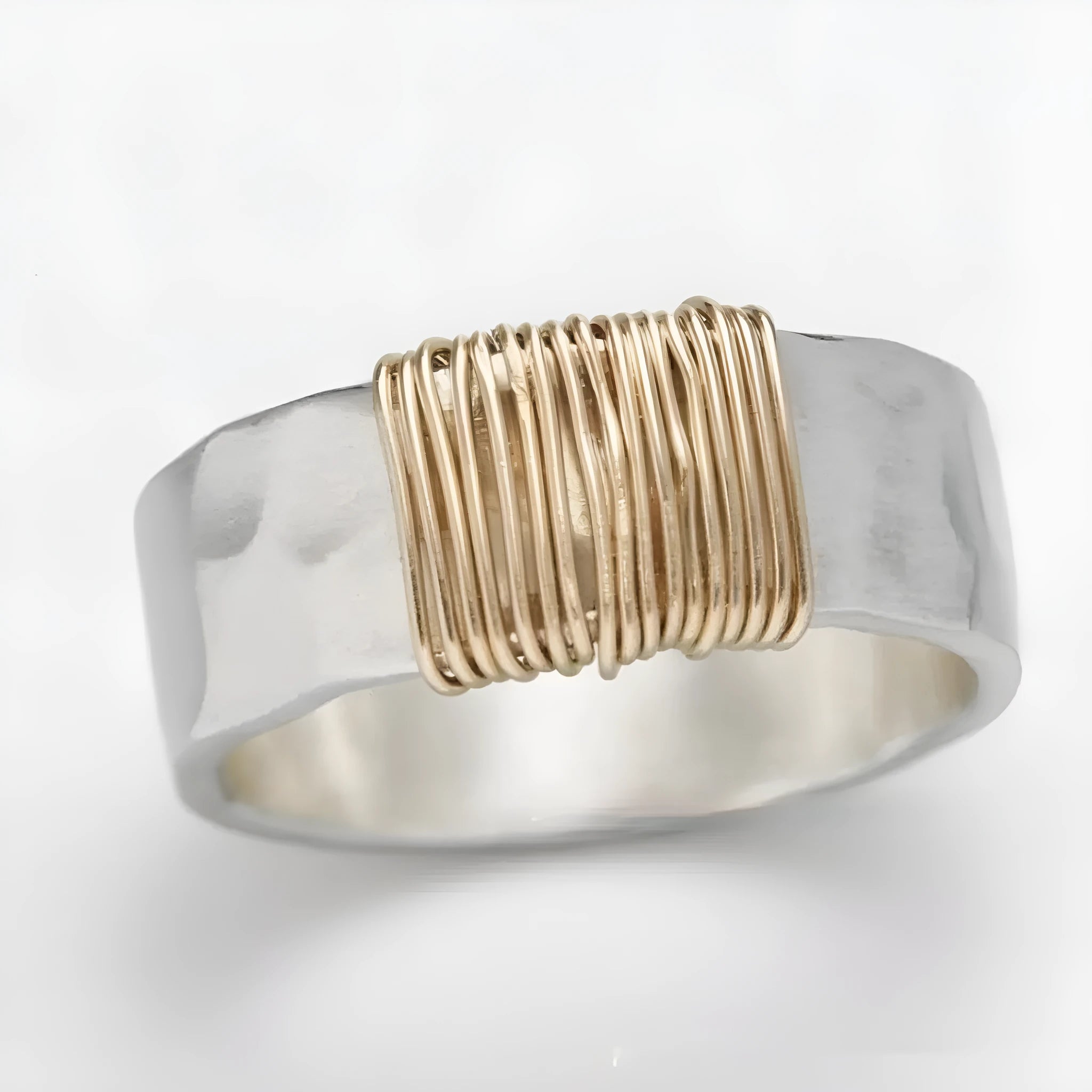 Silver golden geometric coil copper ring for men and women on a grey background.
