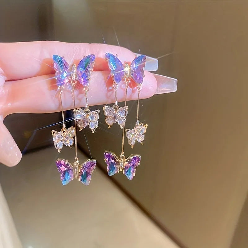 A pair of women's silver-plated alloy tassel drop earrings with crystal flowers in a blue purple butterfly colour.