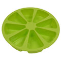 Green silicone cake mold 7 x 4.5cm on a baking tray with a small cupcake inside