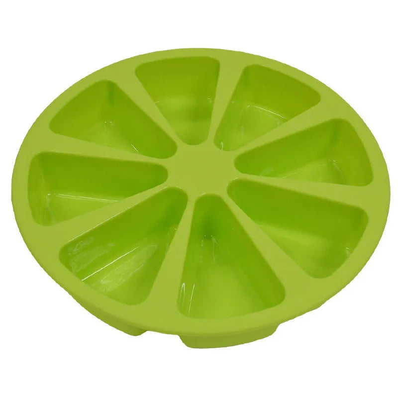 Green silicone cake mold 7 x 4.5cm on a baking tray with a small cupcake inside