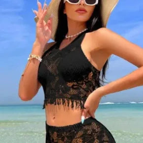 Women's black and white two-piece bikini swimsuit set with lace cover-up skirt
