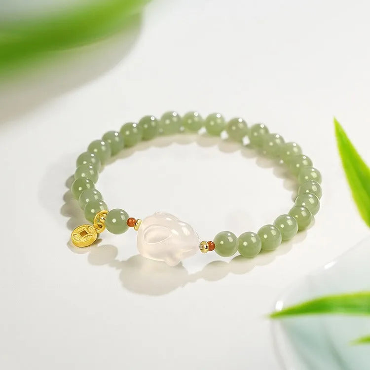 Handmade Hetian jade rabbit bracelet for women in glass with sweet rabbit charm on wrist.
