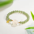 Handmade Hetian jade rabbit bracelet for women in glass with sweet rabbit charm on wrist.