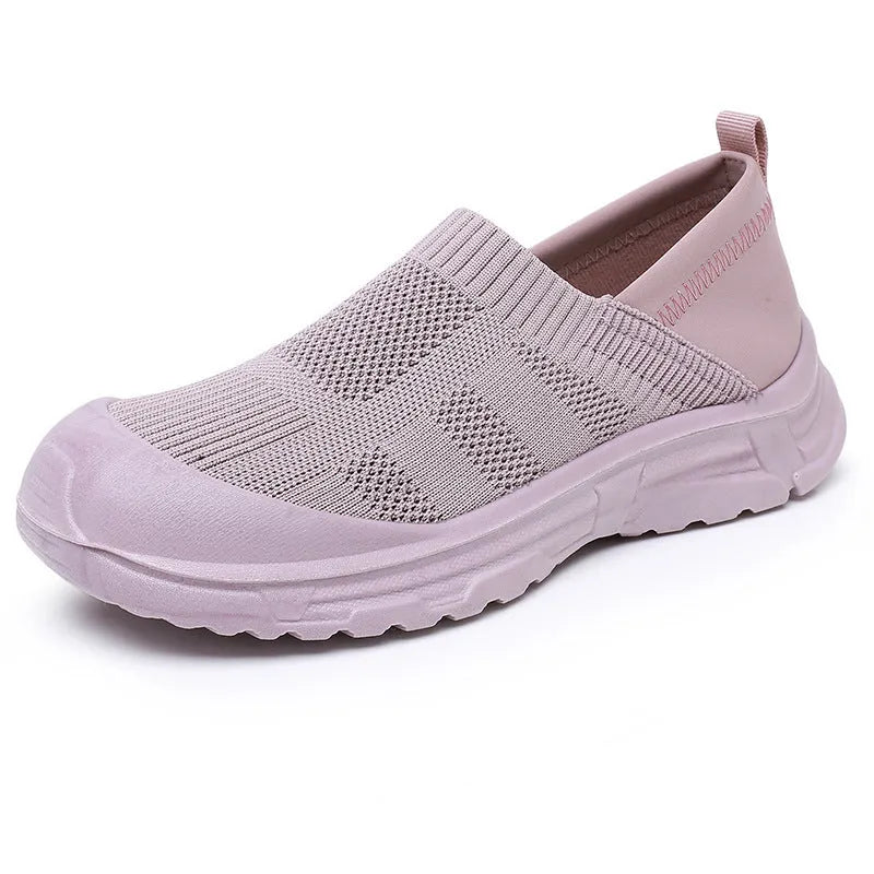 Women's black oversleeve shoes with round toe and soft flat PVC sole.