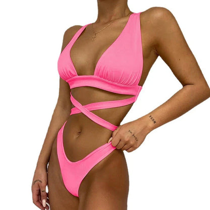 Women's solid colour cross bikini swimsuit with removable chest pads in black, showing front design detail