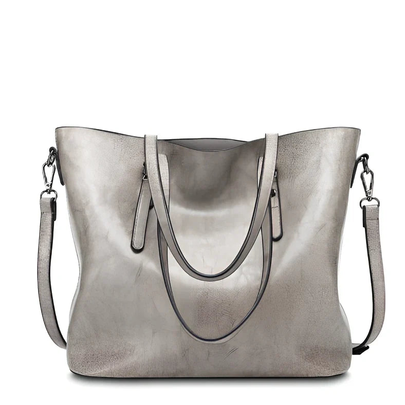 Black oil leather tote bag with square shape, zipper top, soft handle, and internal pockets for winter use