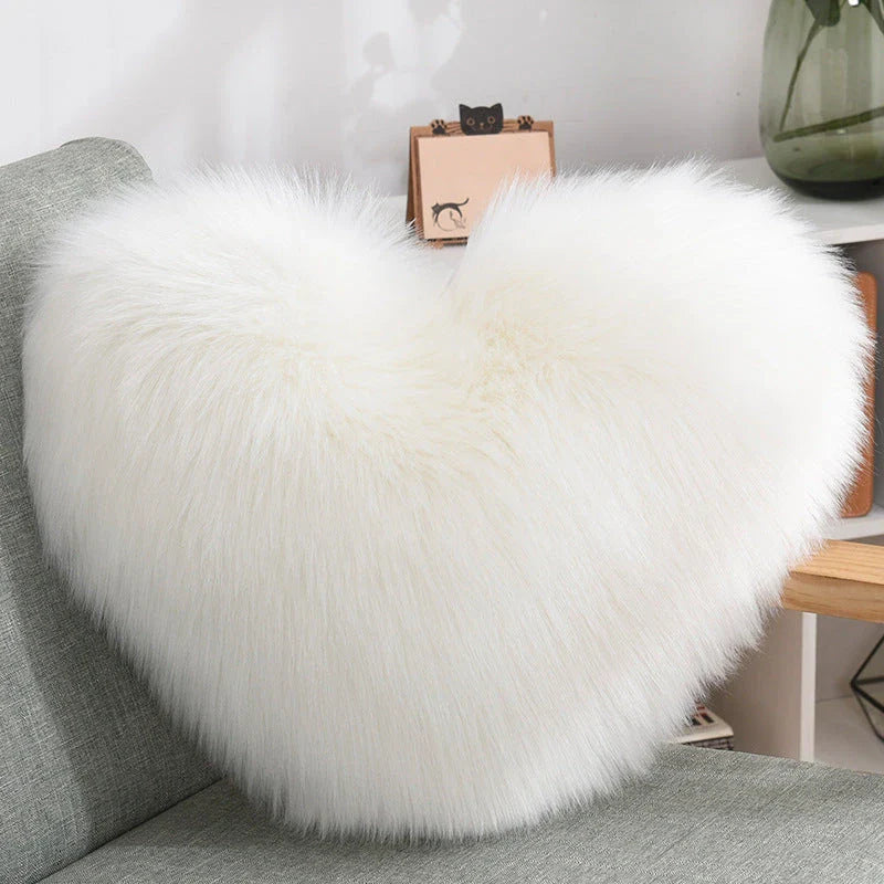 Plush heart-shaped throw pillows in various colors and styles for cozy sofa decor