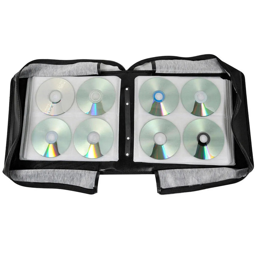 Black Oxford fabric CD storage binder with a zipper and top hand strap, open to show disc sleeves.