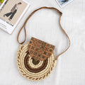 Round straw woven crossbody bag in beige, 25cm diameter, with adjustable shoulder strap, displayed on a neutral background